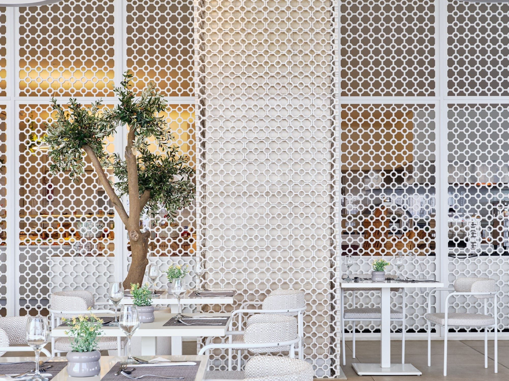 a room with a tree and chairs