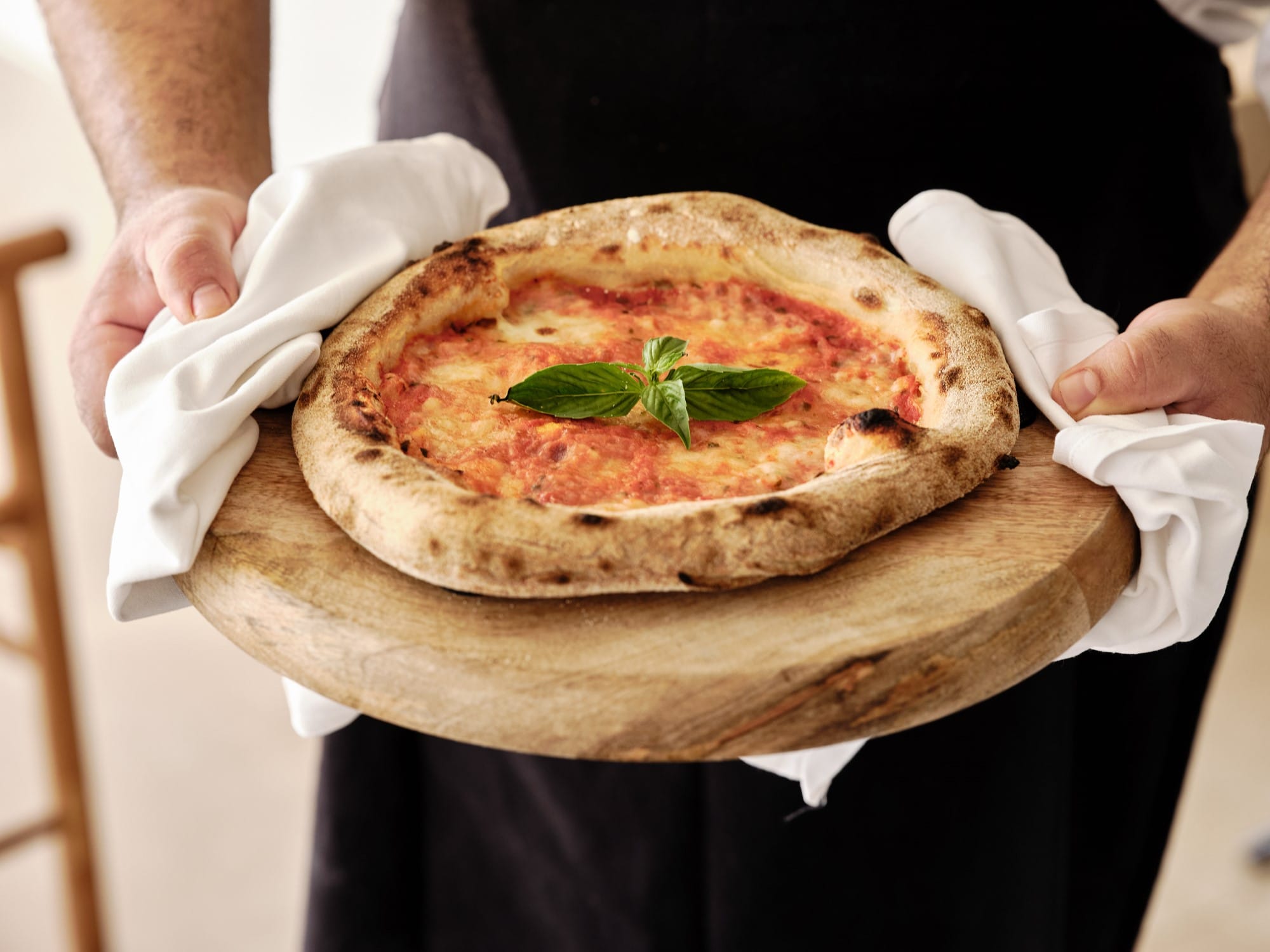 a person holding a pizza