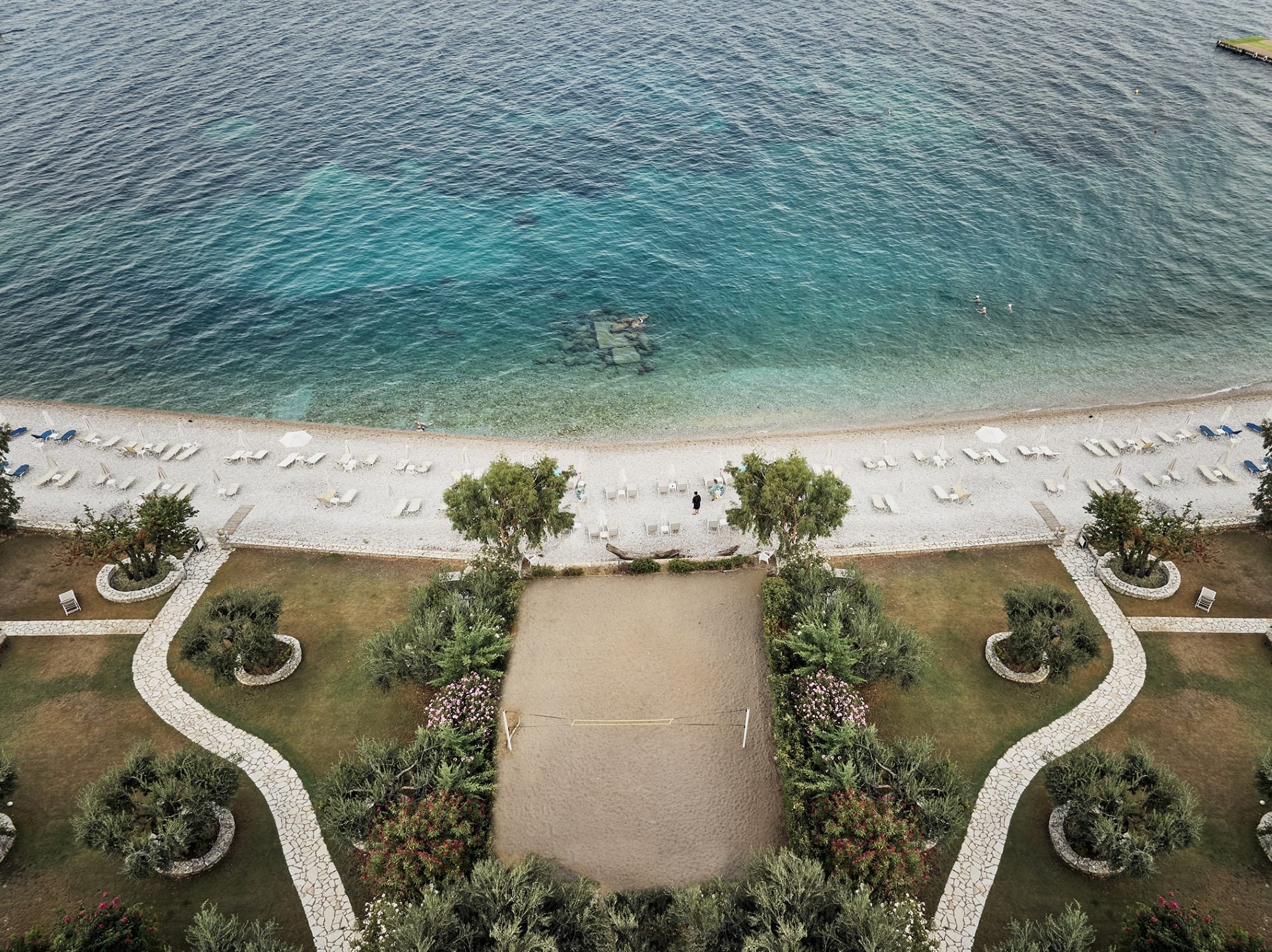 a beach with a chair and trees
