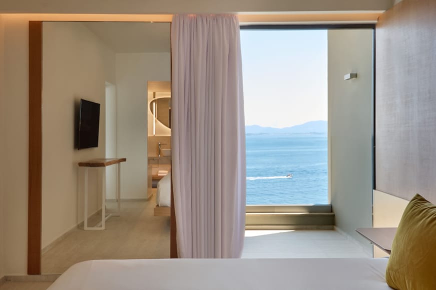 a room with a window and a view of the ocean