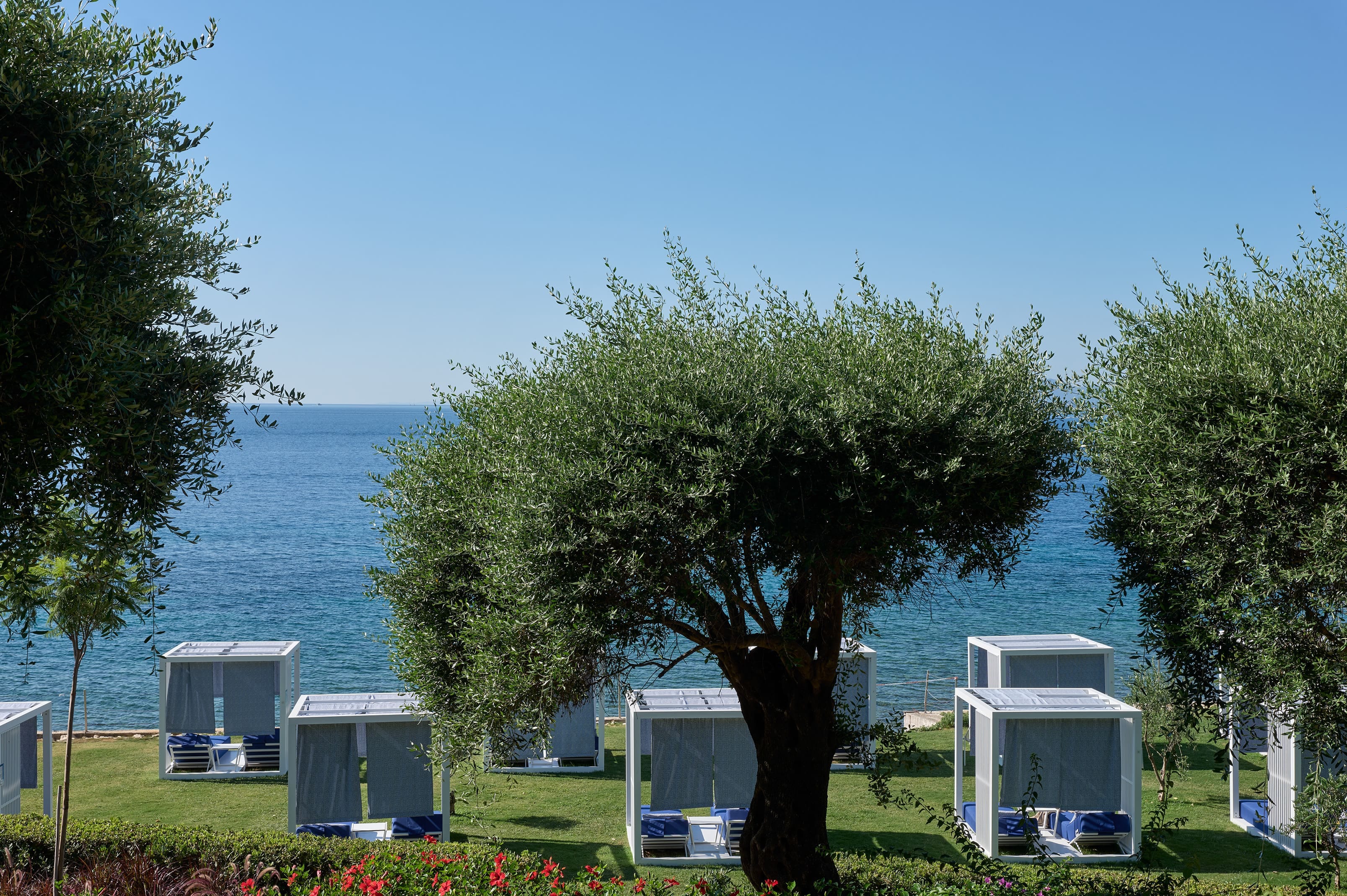 a group of white buildings next to a body of water