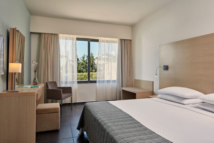 a bedroom with a large window