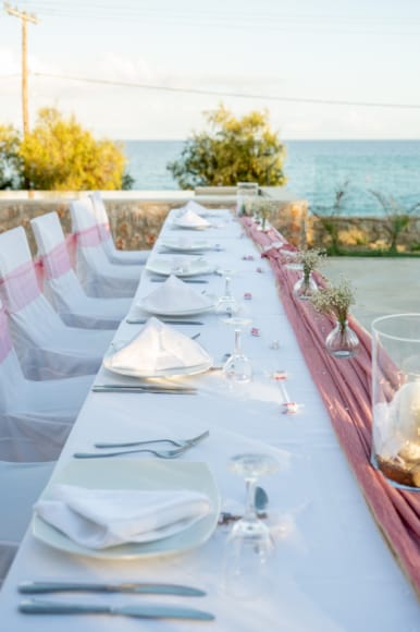 a table set with white plates and silverware