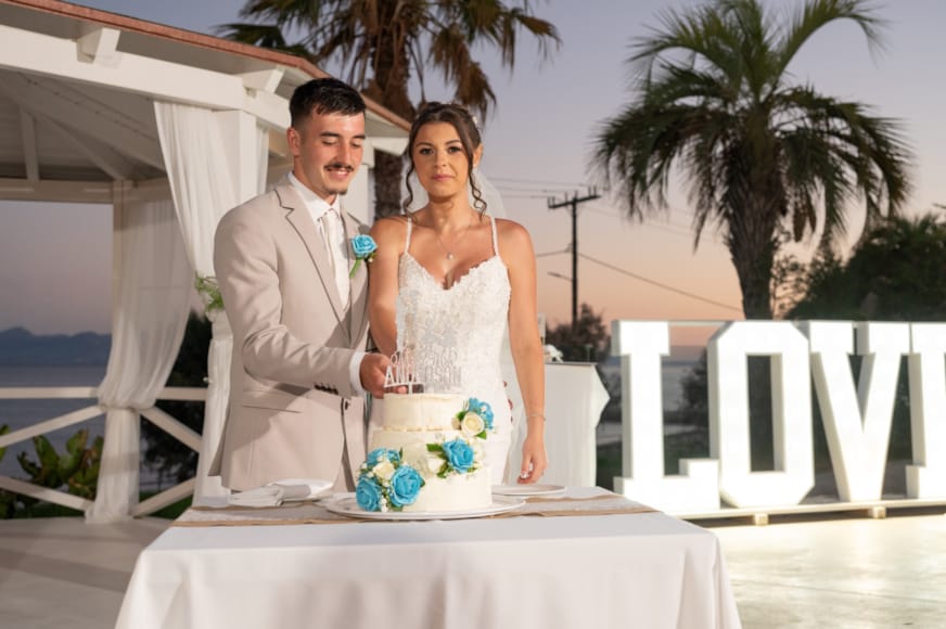 a man and woman holding a cake