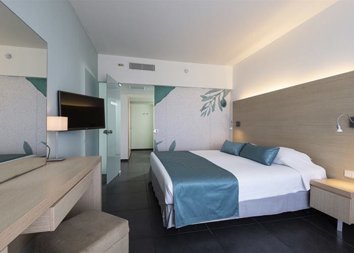 a hotel room with a bed and a desk