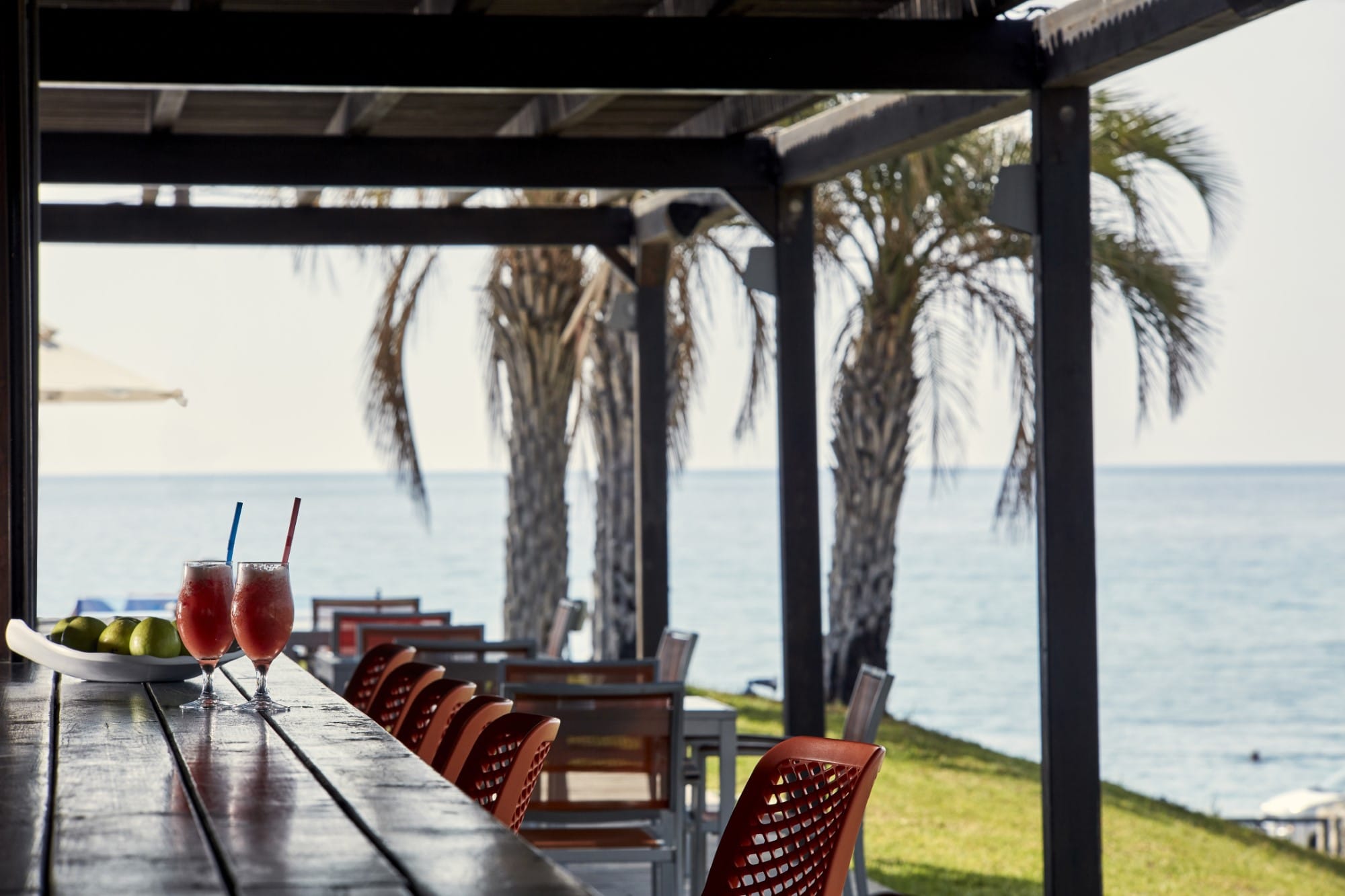 a table with drinks on it by a body of water