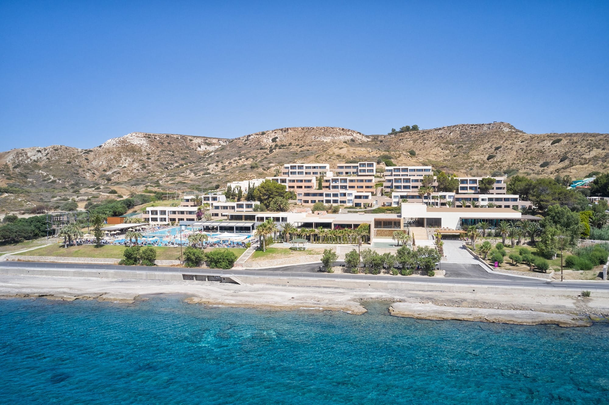 a beach with buildings and trees