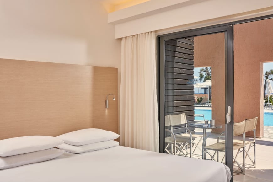 a hotel room with a bed and chairs