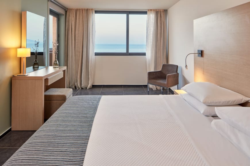 a hotel room with a bed and a desk