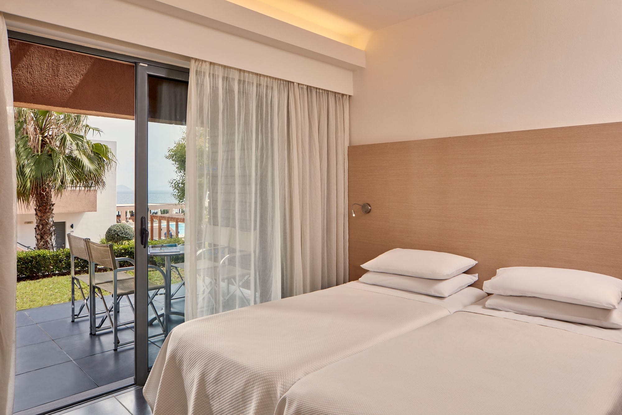 a bedroom with a large glass door