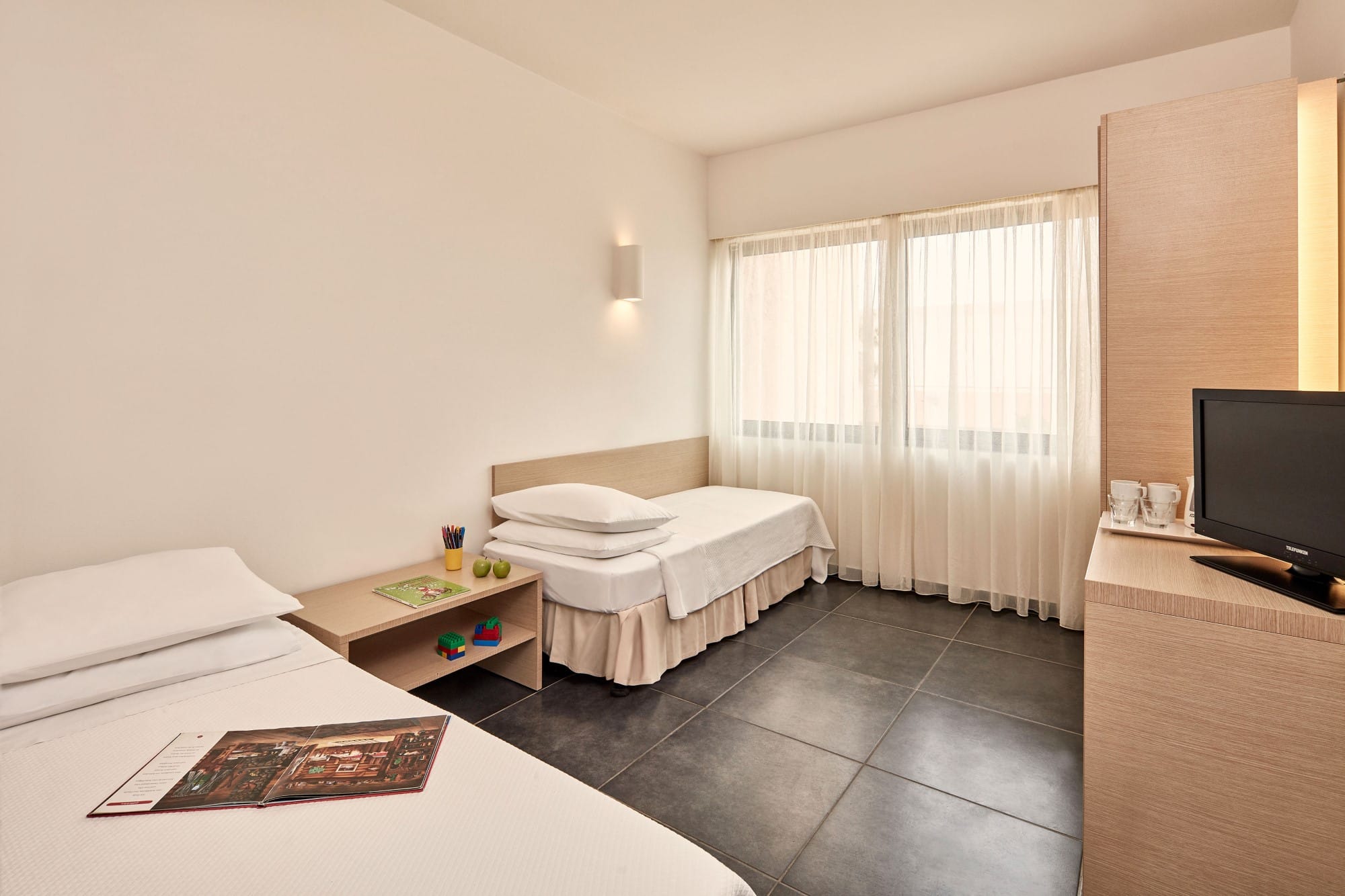 a room with a bed and a tv