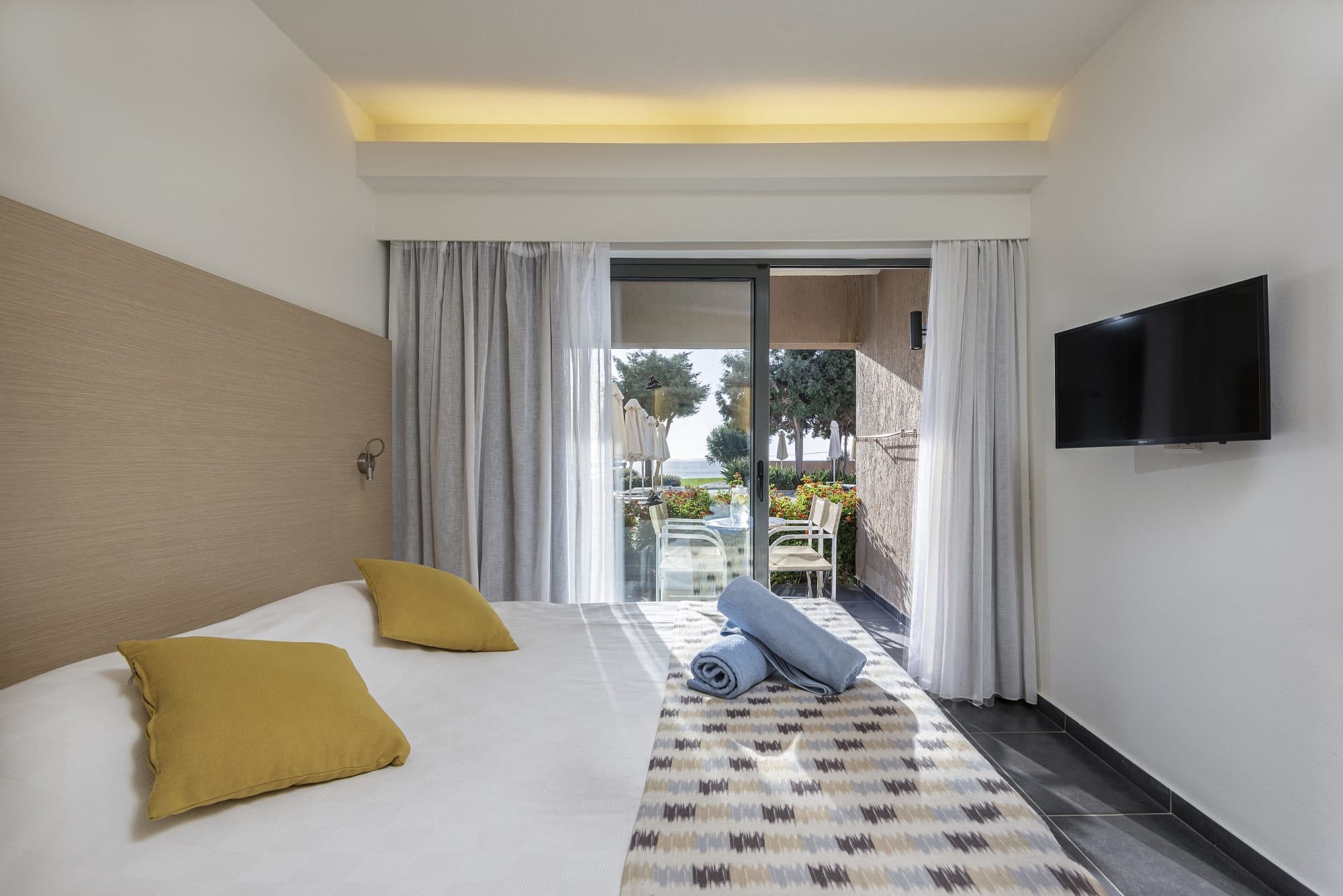 a hotel room with a large glass door