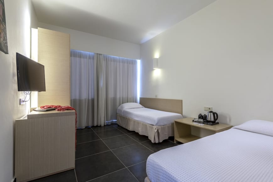a hotel room with two beds