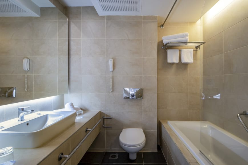 a bathroom with a tub sink and toilet
