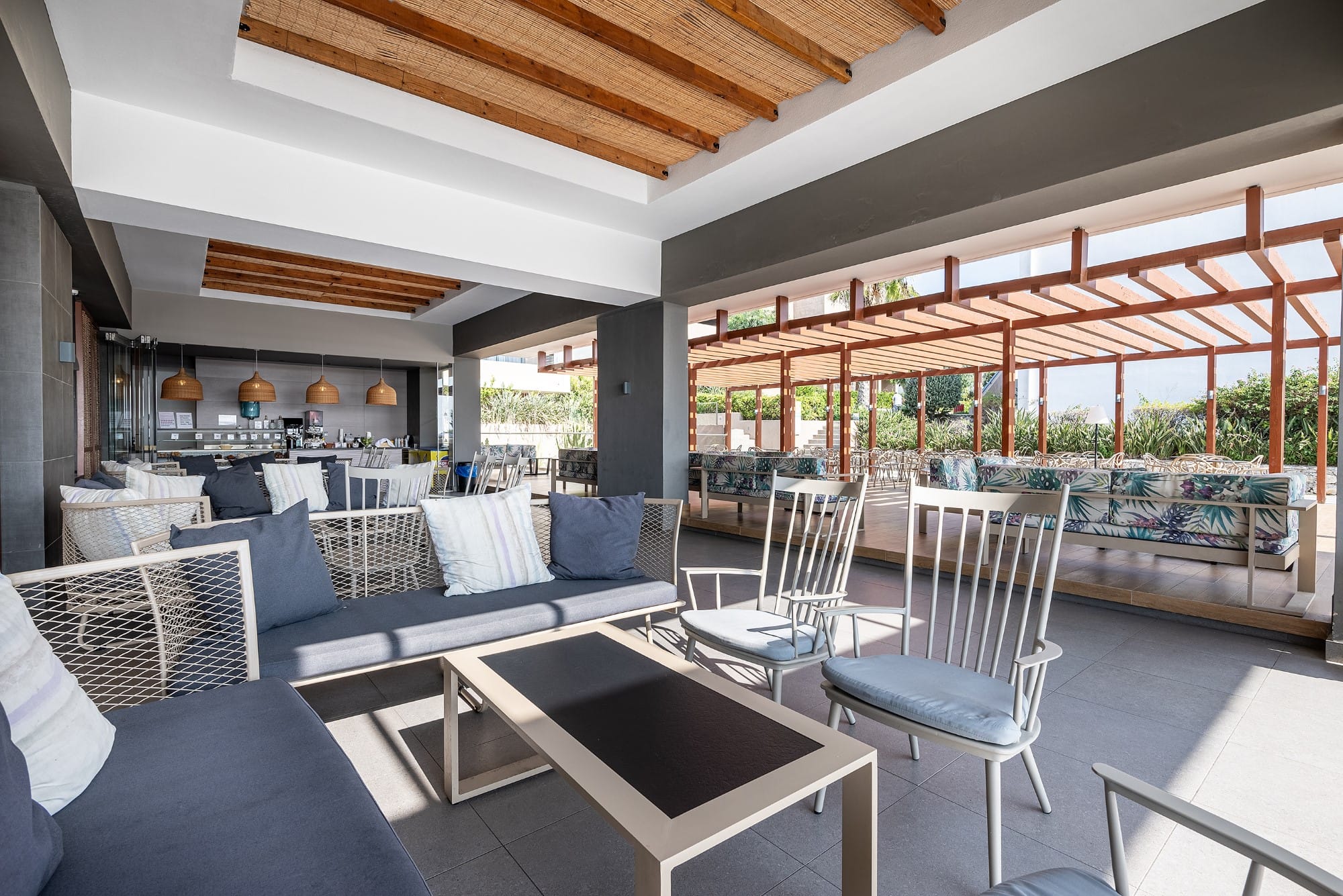 a room with a table chairs and a large window