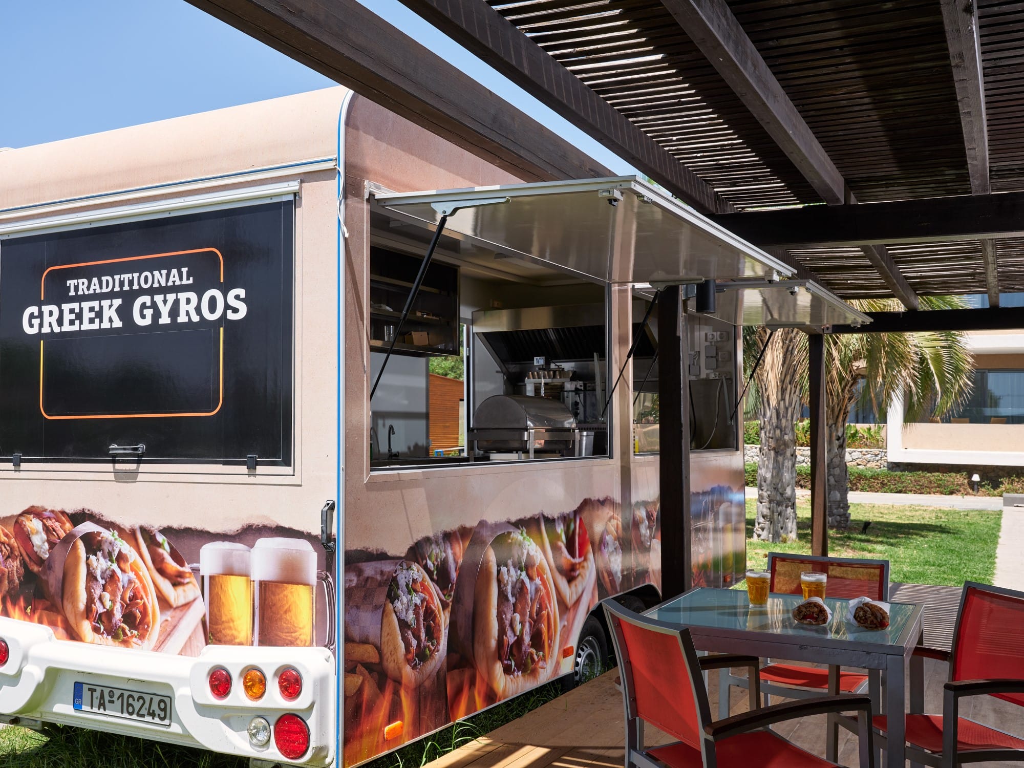 a food truck with a table and chairs