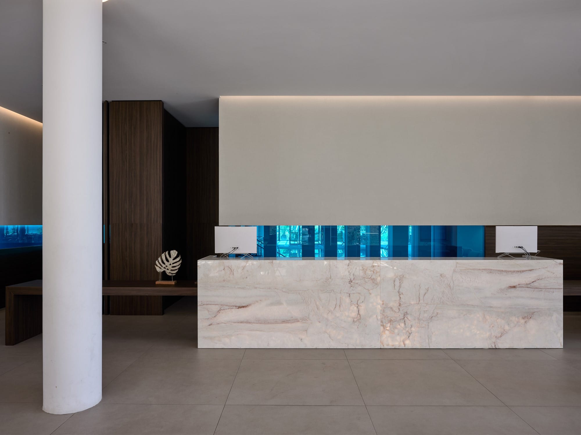 a room with a white wall and a white table with blue and white striped cloths