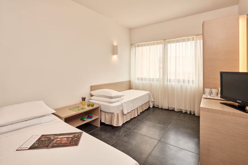 a room with a bed and a tv