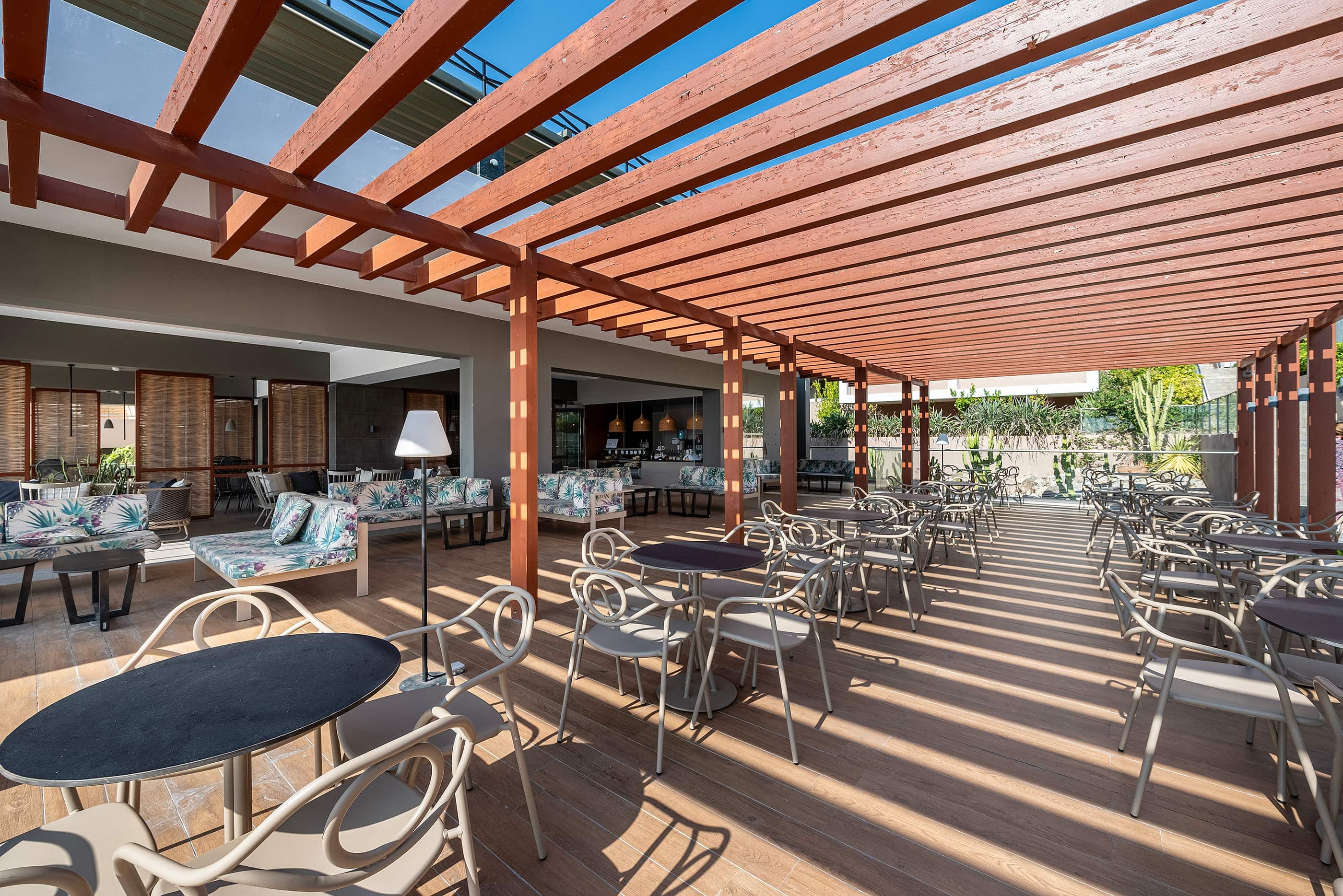 a patio with tables and chairs