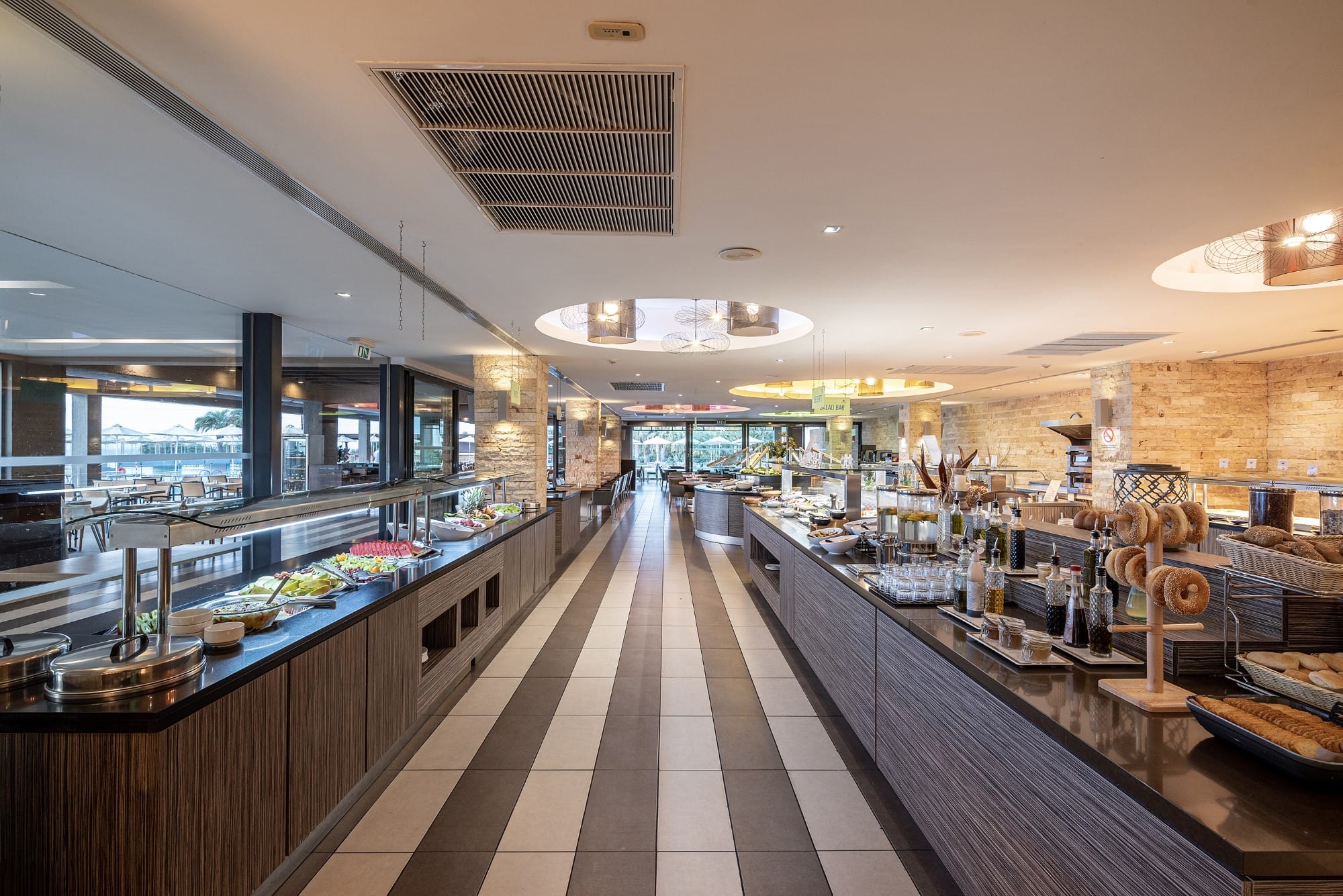 a long hallway with tables and chairs