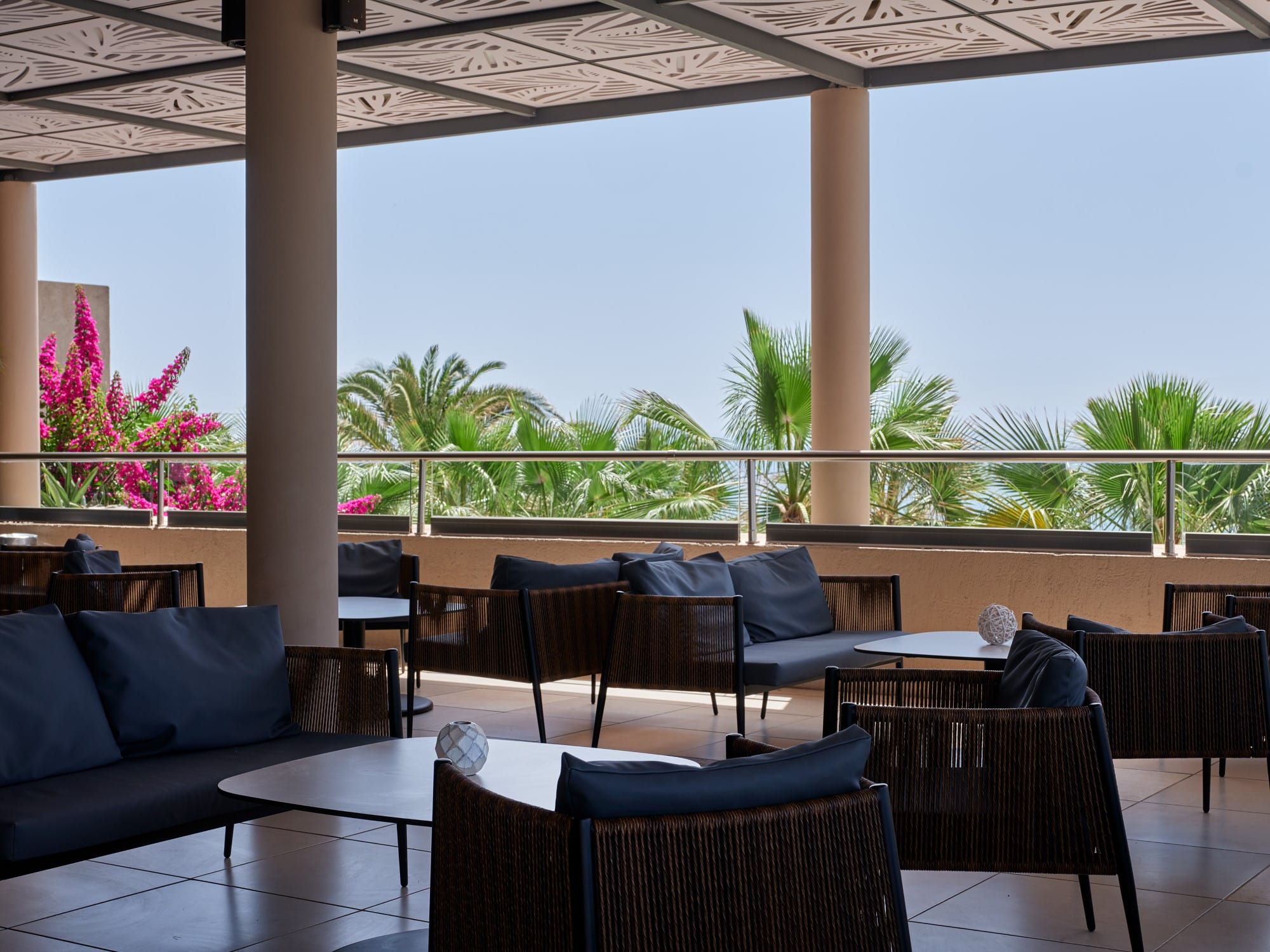 a room with a table and chairs and a view of the ocean