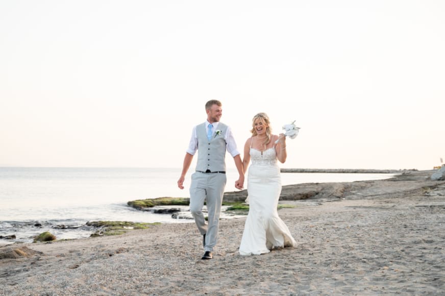 a man and woman walking on a beach