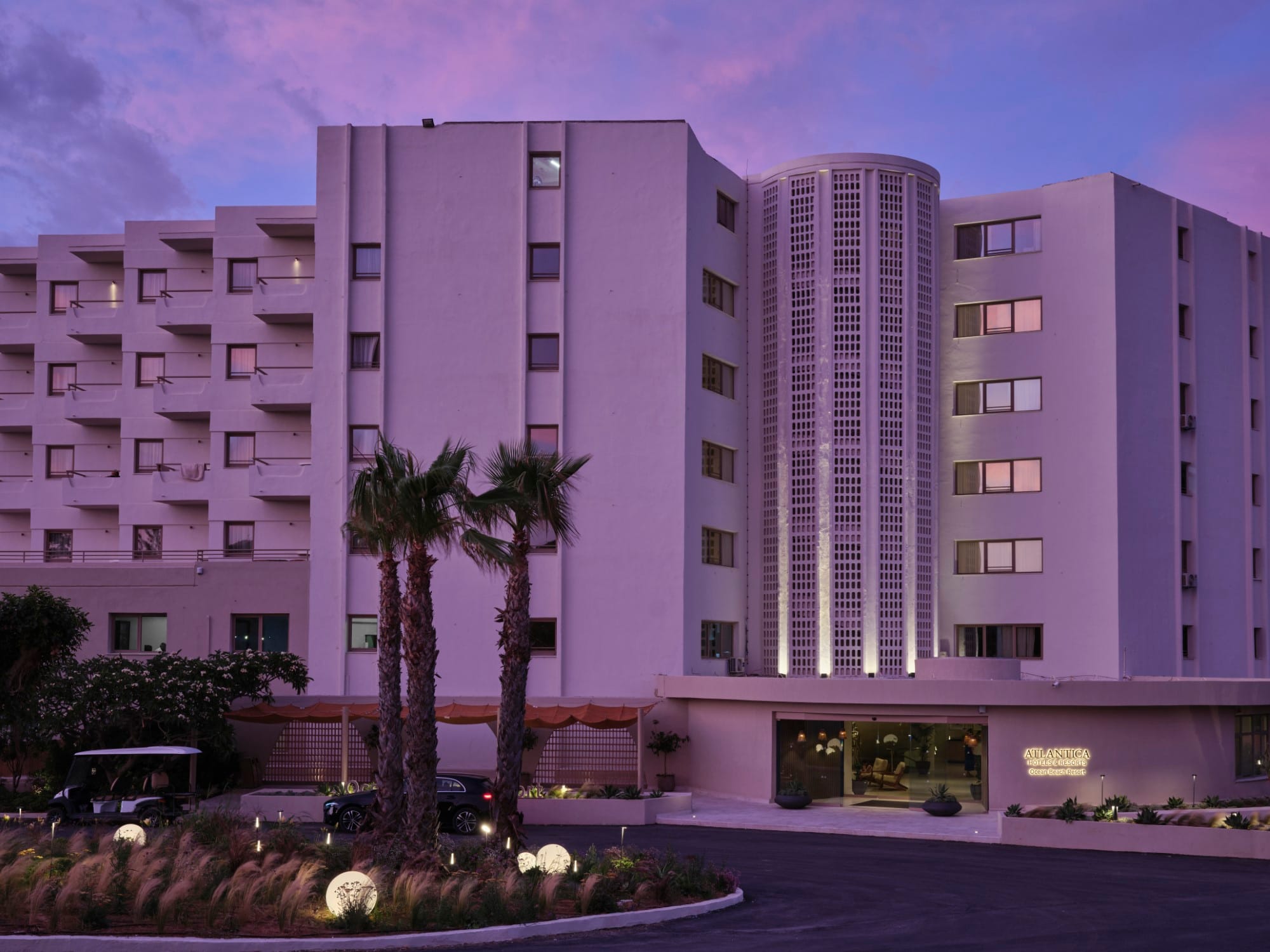 a building with palm trees in front