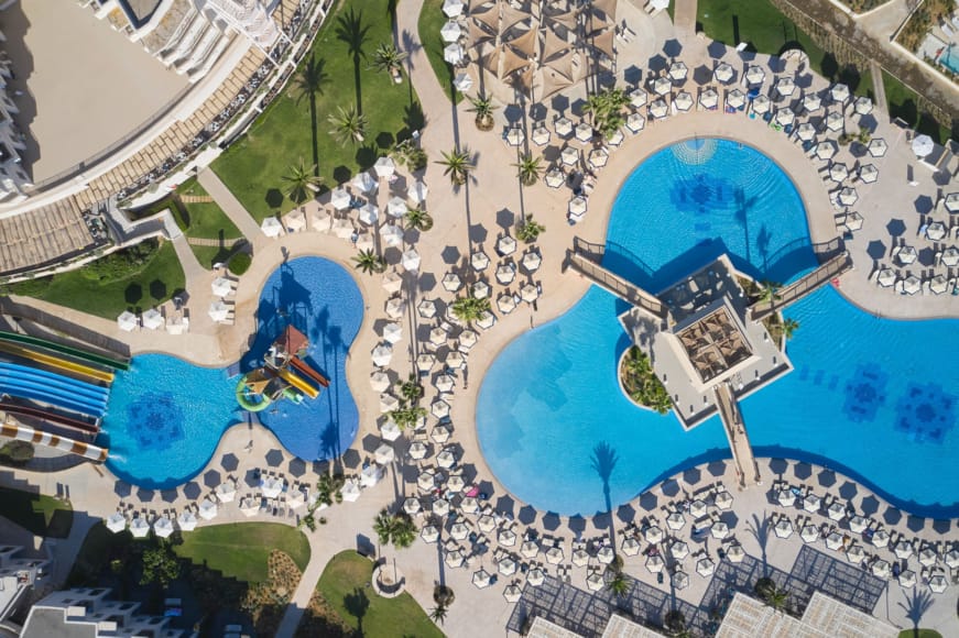 a large group of people in a large area with a pool