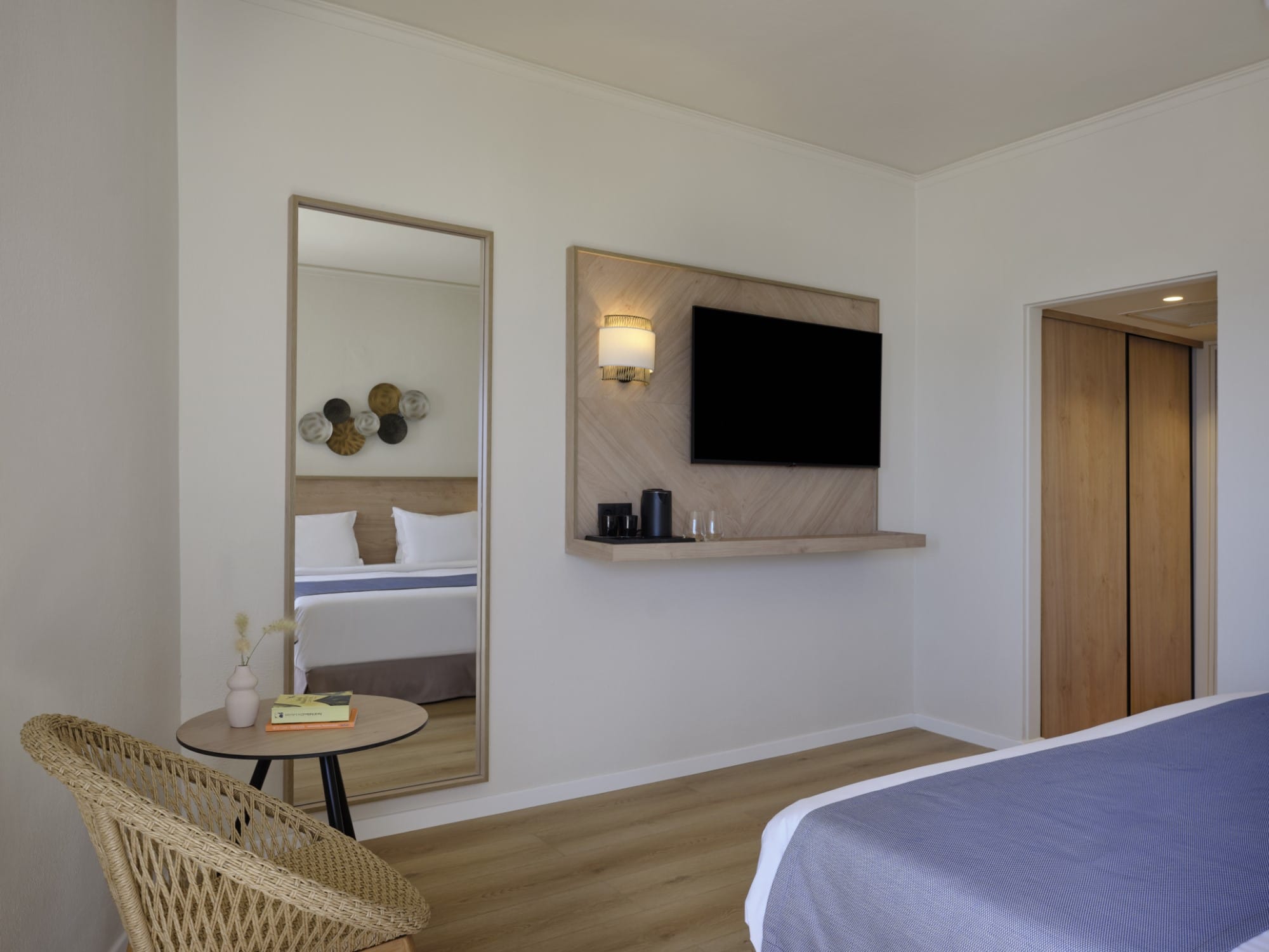 a room with a mirror and a bed