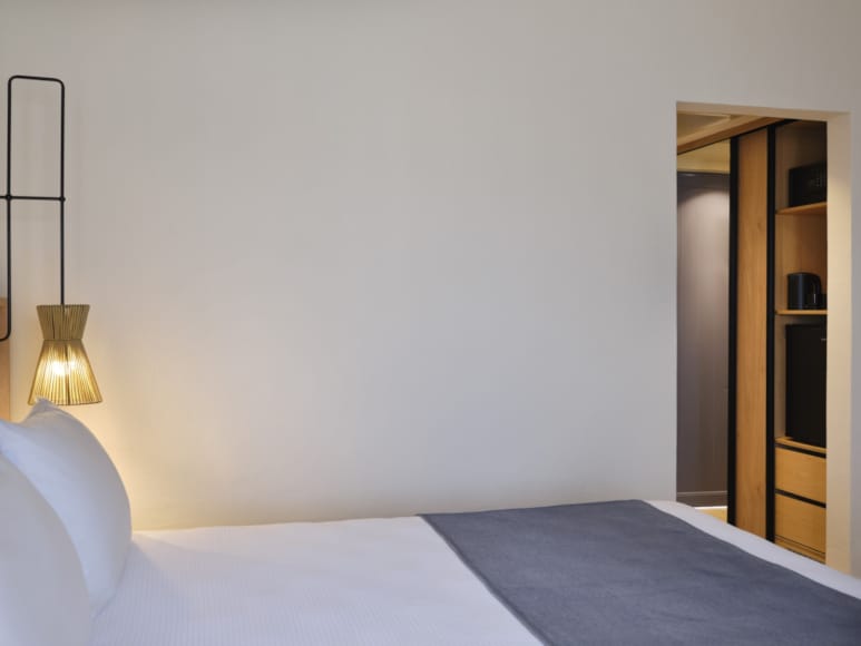 a bed with a lamp on the side