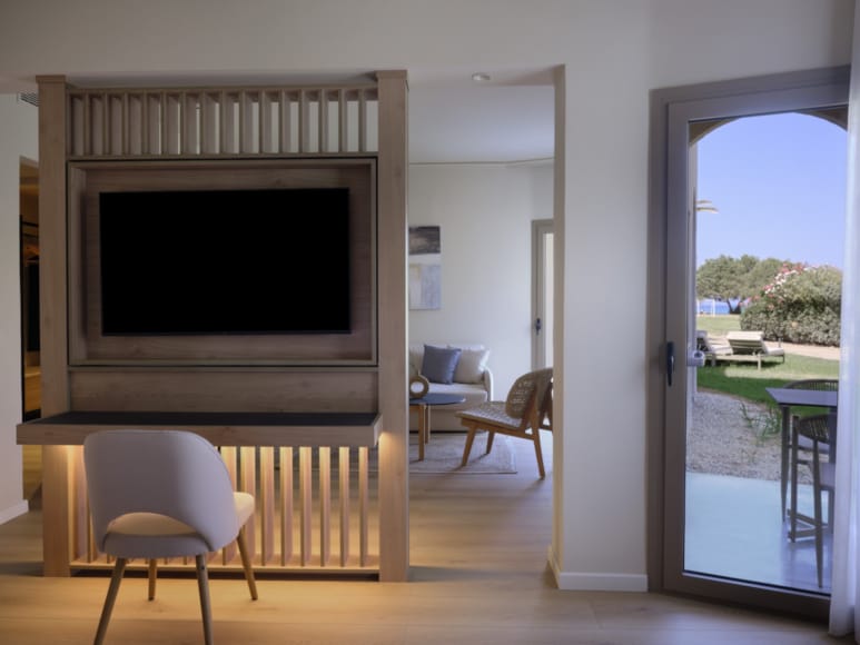 a living room with a tv and chairs