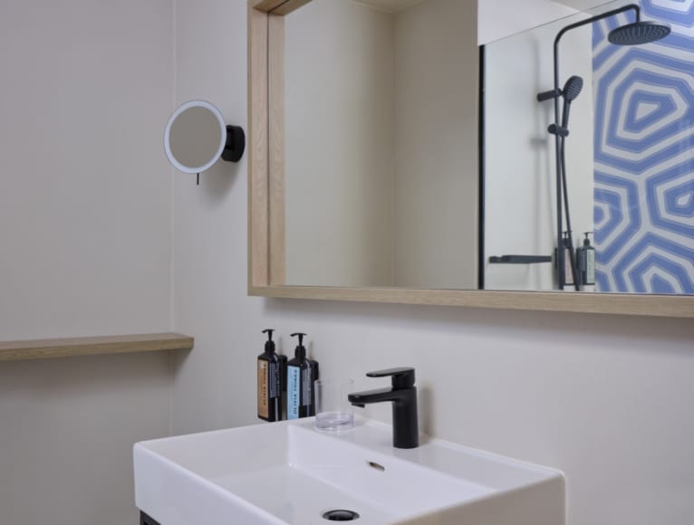 a bathroom with a mirror and sink