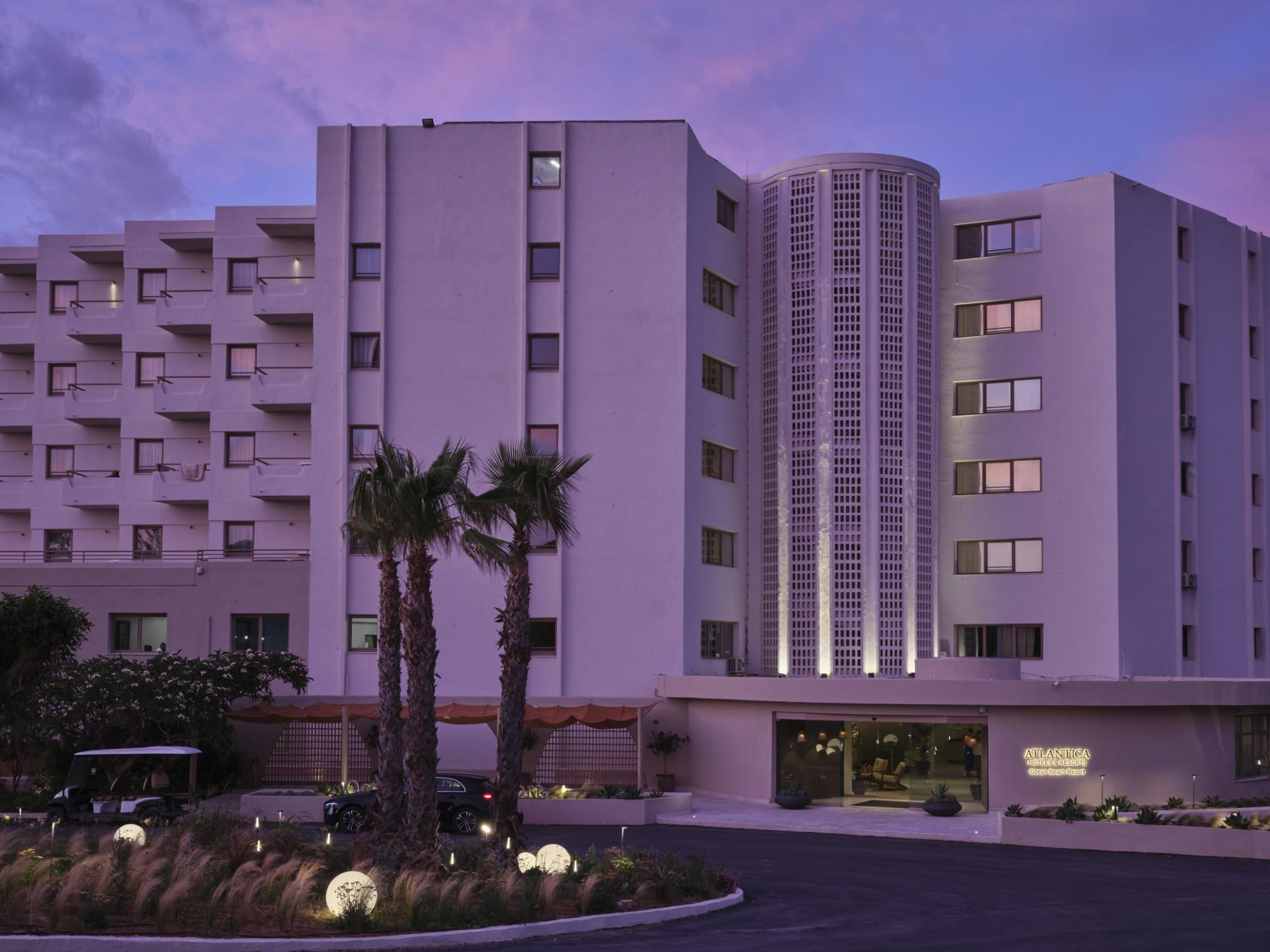 a building with palm trees in front