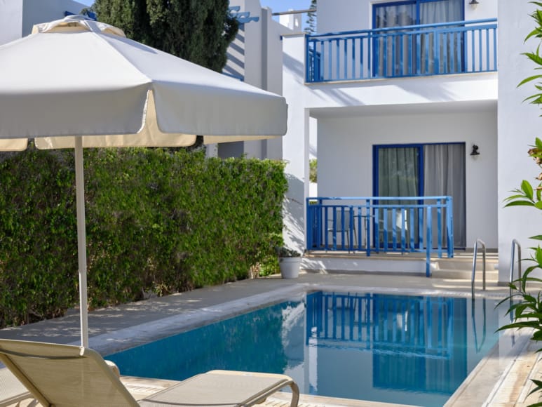 a pool with a white umbrella