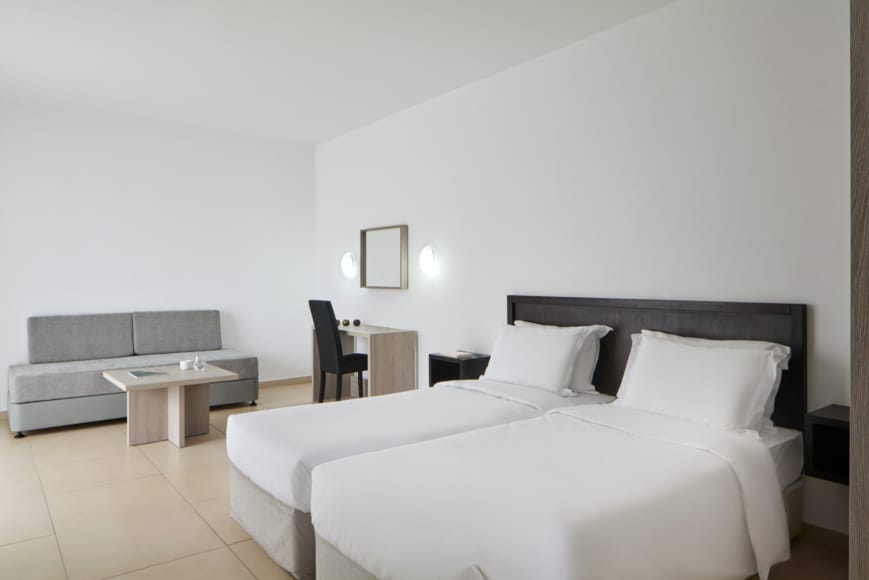 a bedroom with a bed and couch