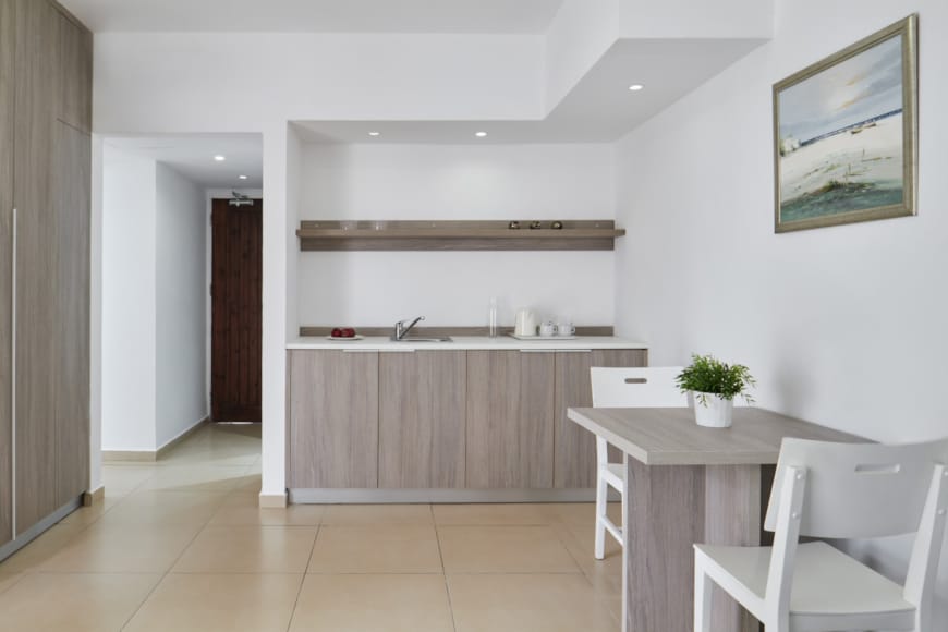 a kitchen with a table and chairs