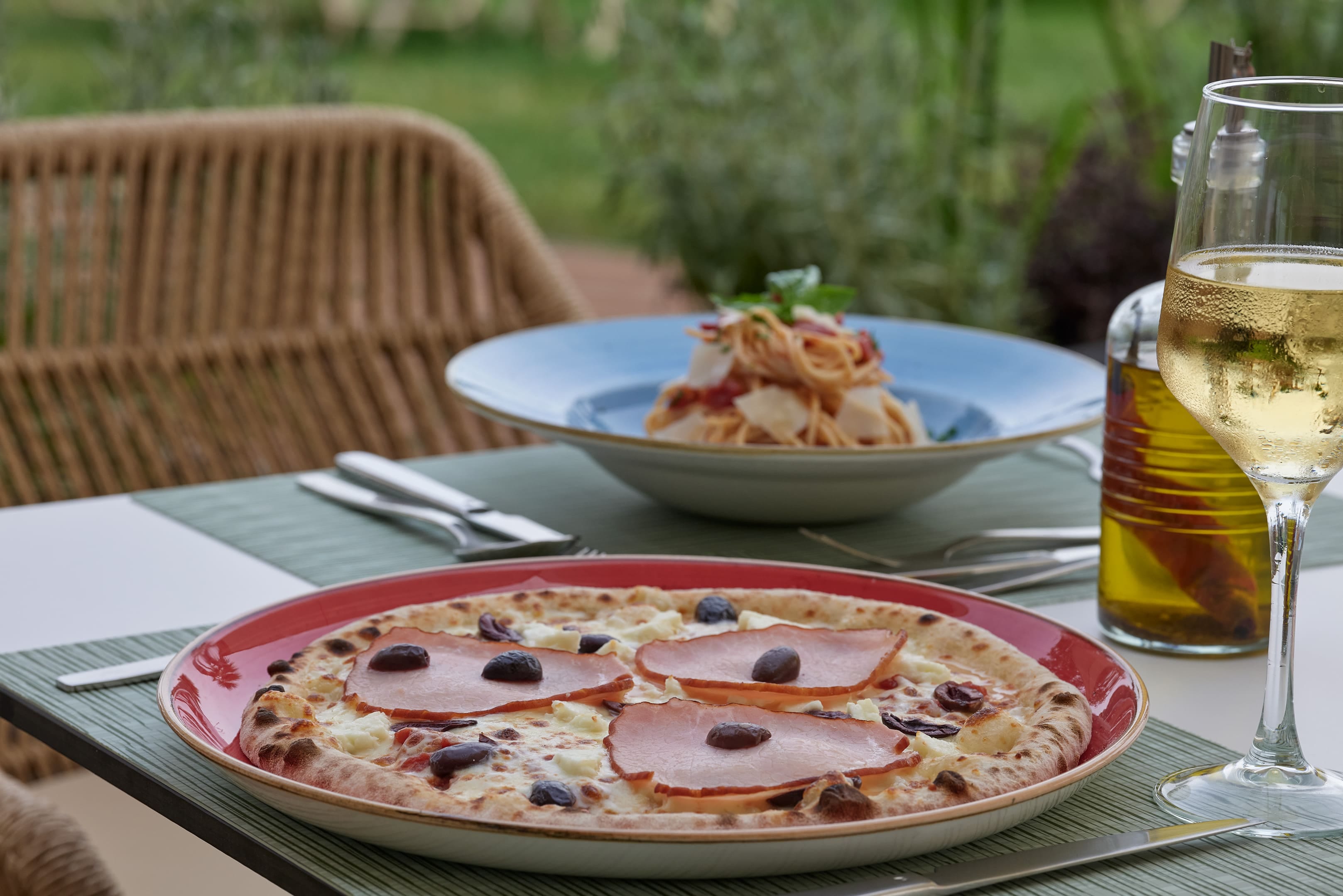 a plate of food and a glass of beer on a table