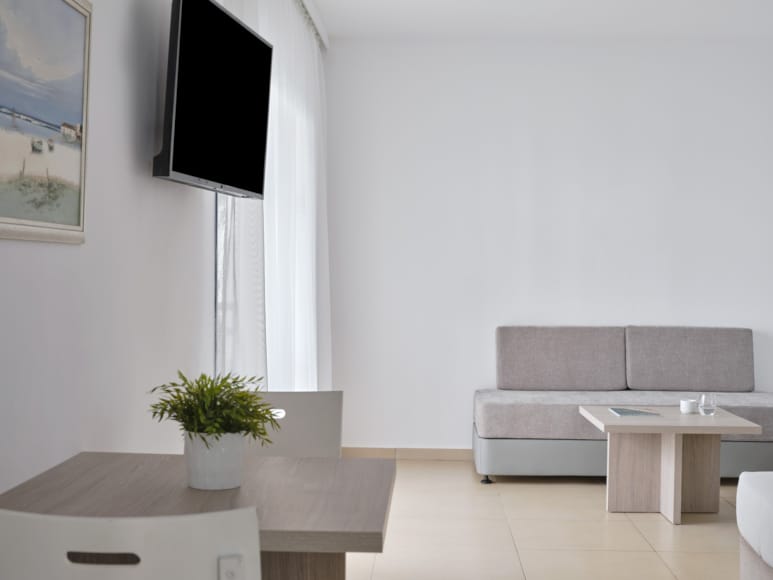 a room with white walls and a tv on the wall