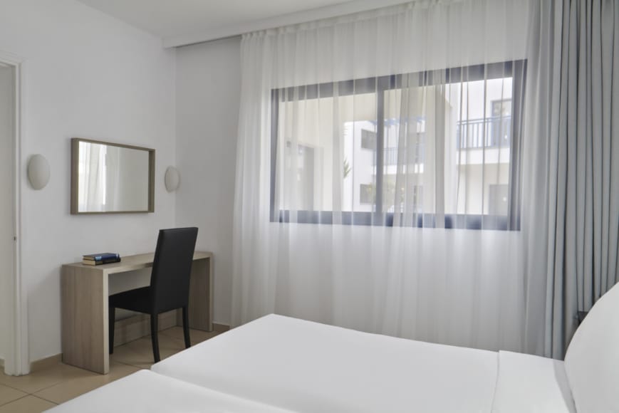 a room with a bed and a desk