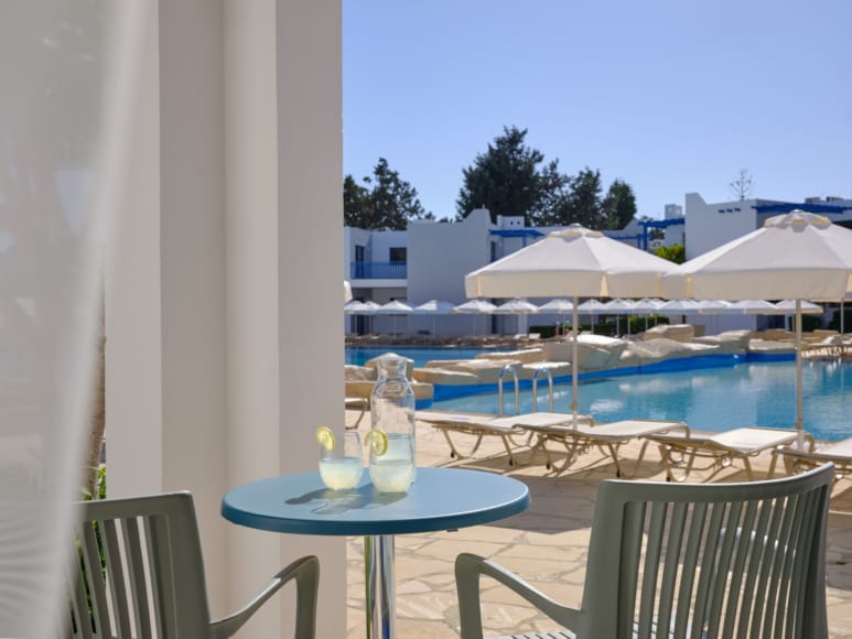 a table and chairs by a pool