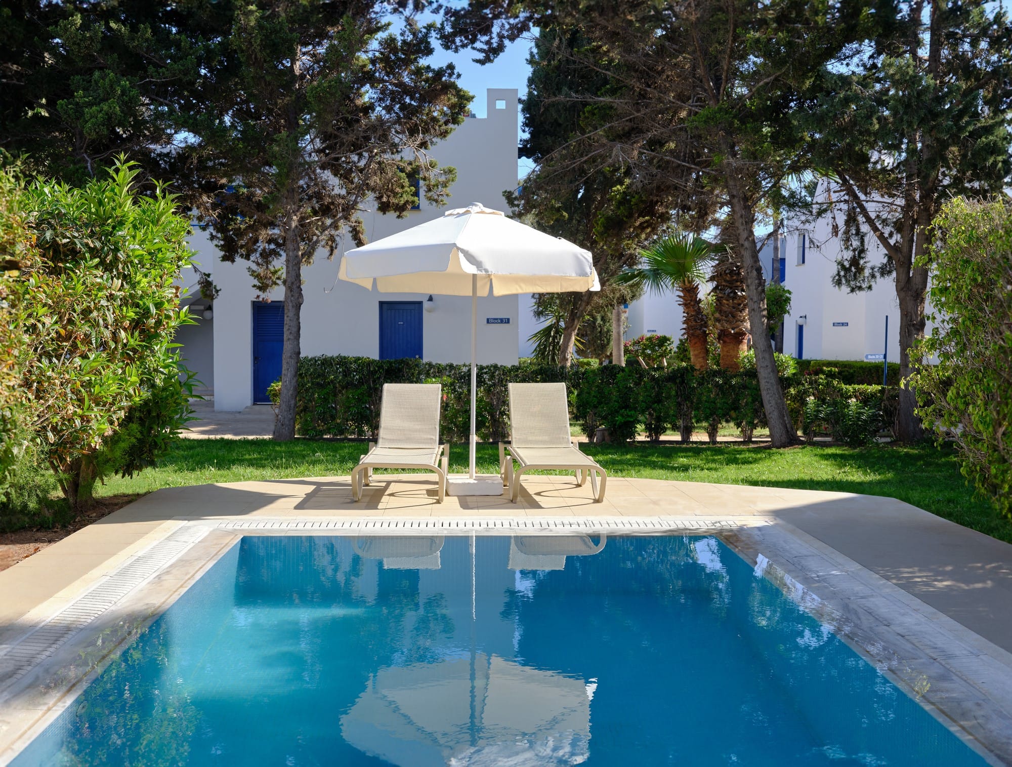 a pool with chairs and an umbrella