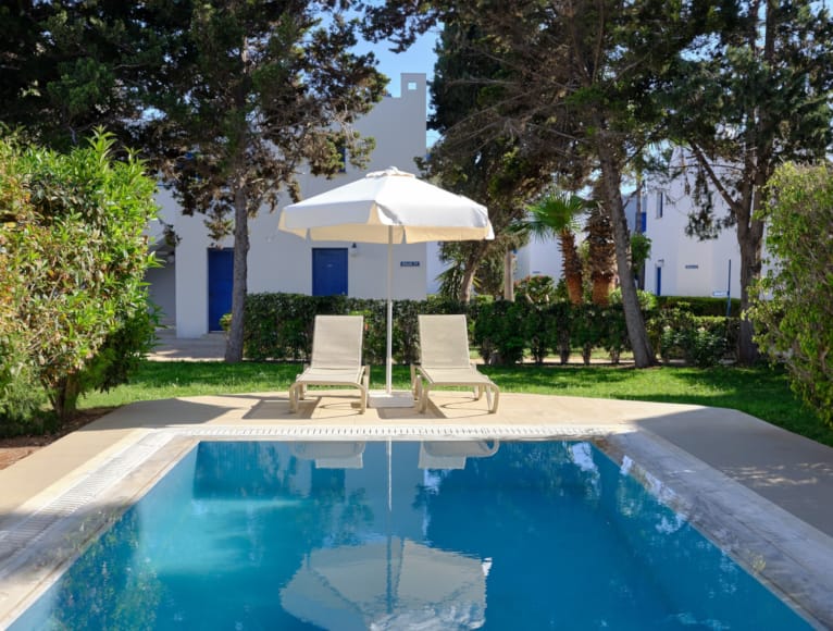 a pool with chairs and an umbrella