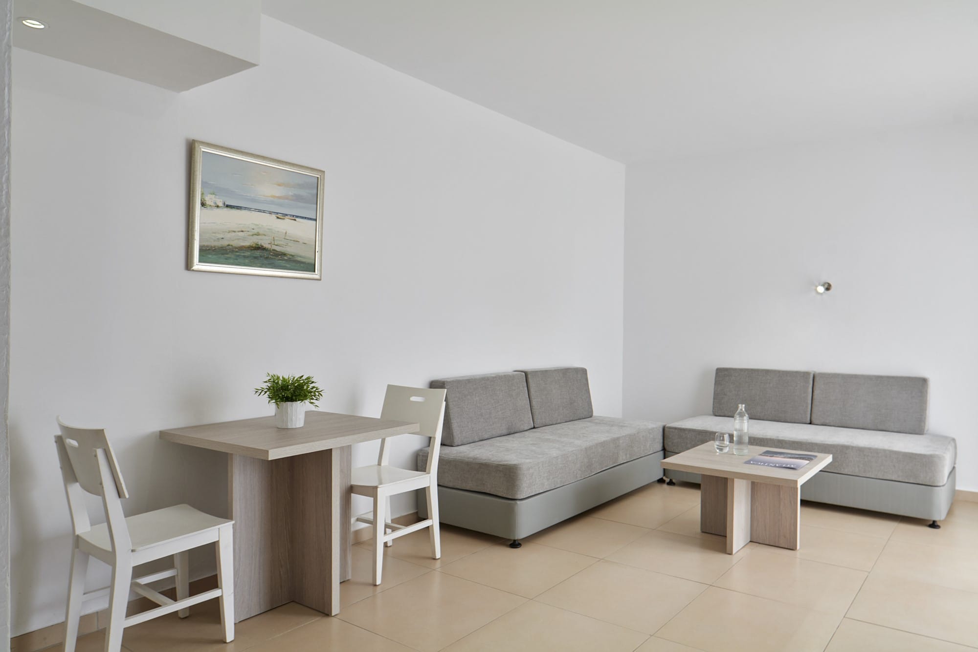 a room with a couch and chairs