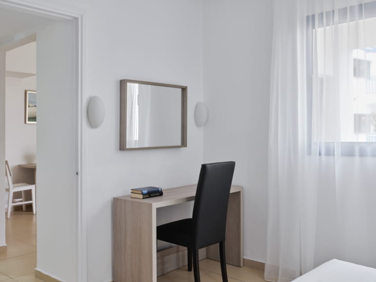 a room with a desk and a mirror