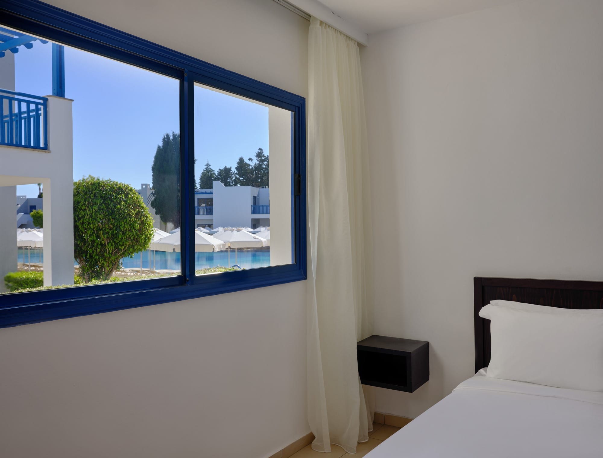 a bedroom with a large window