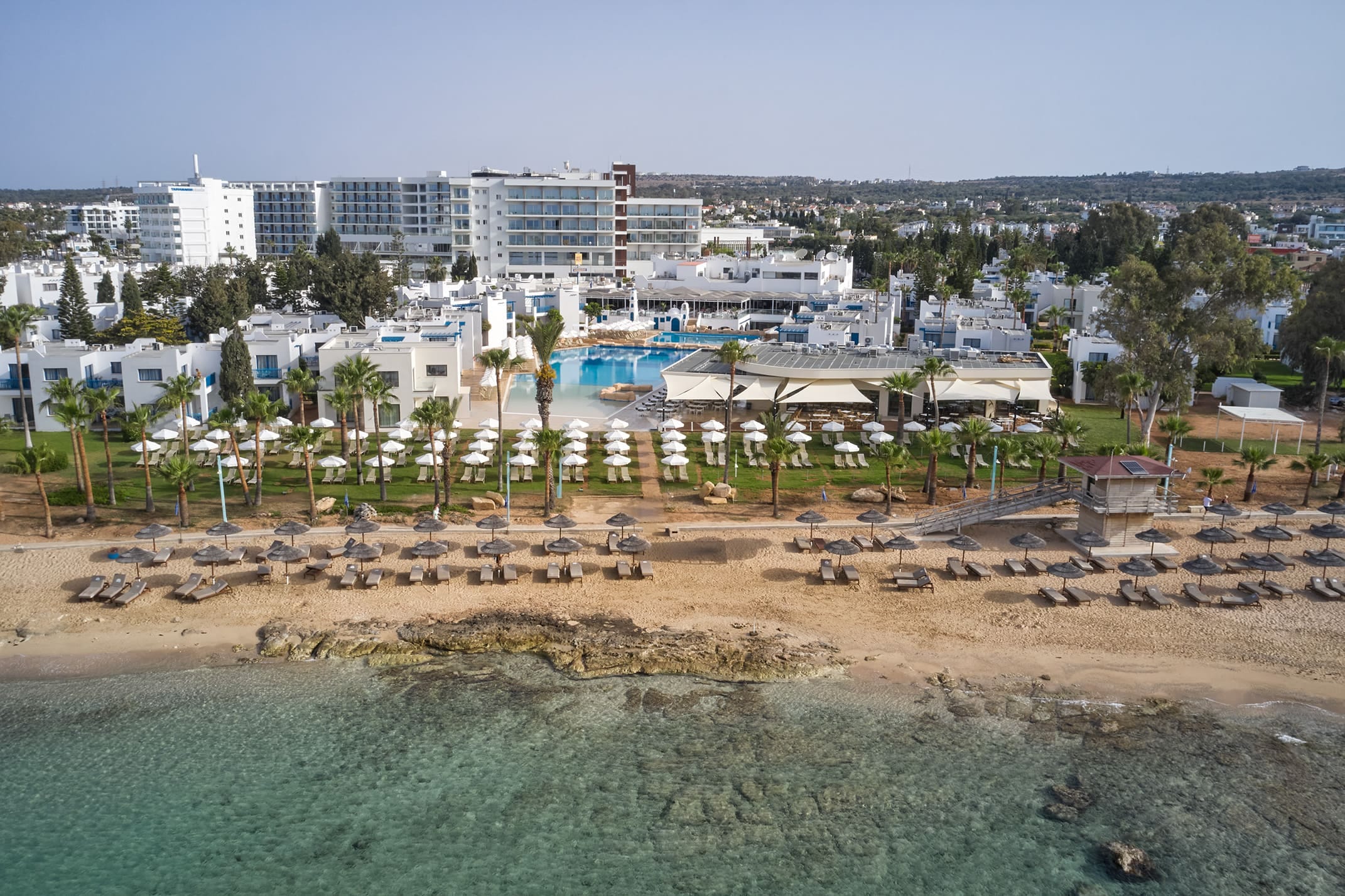 a beach with many buildings in the background