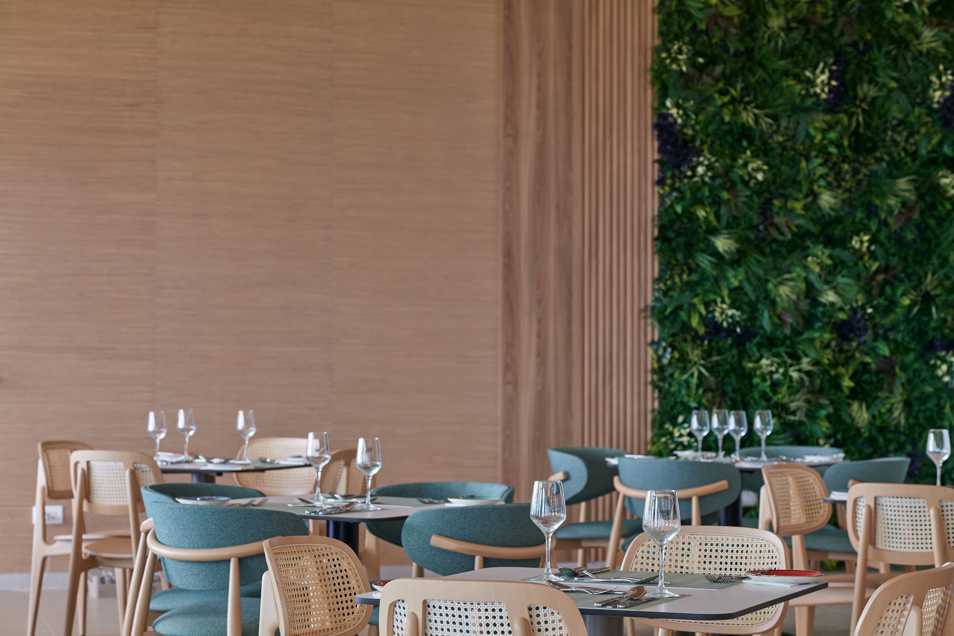 a set of tables with chairs and glasses on them