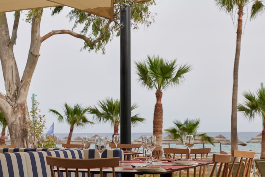 a beach with tables and chairs
