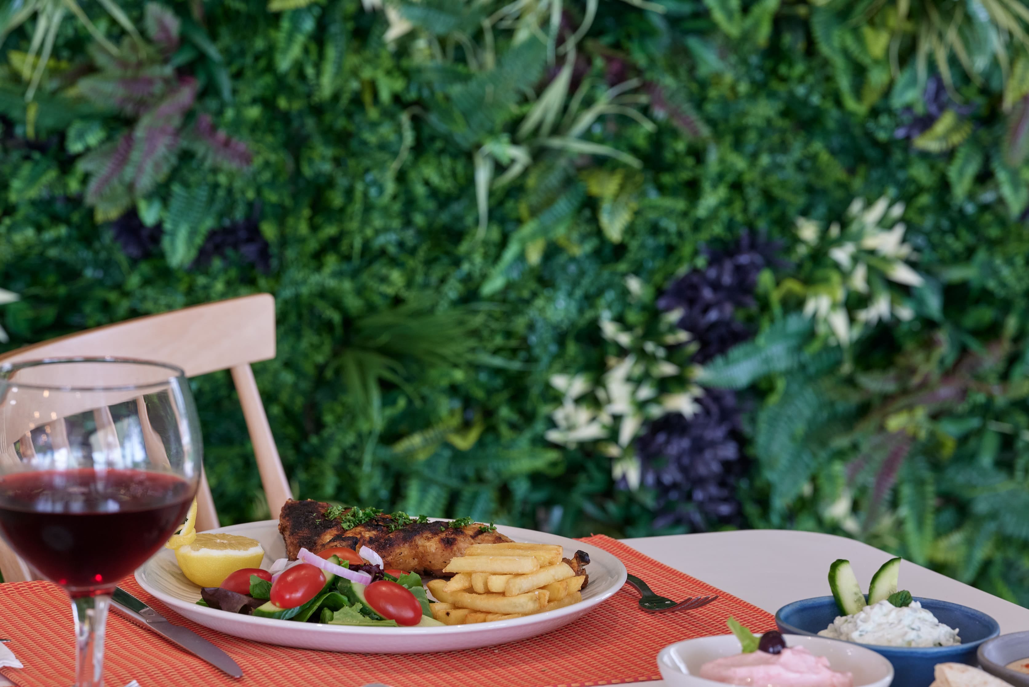 a plate of food and a glass of wine on a table