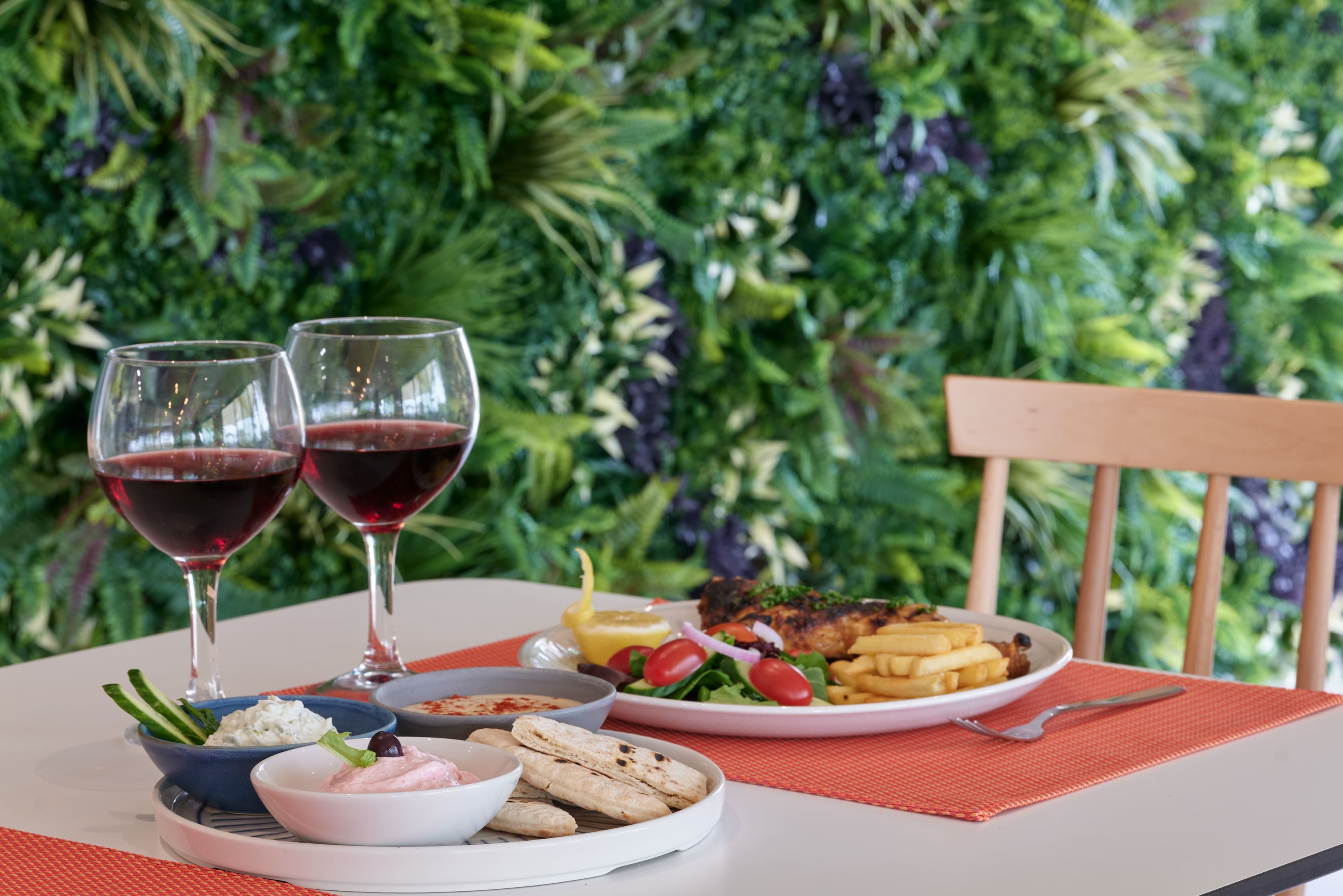 a table with glasses of wine and food on it